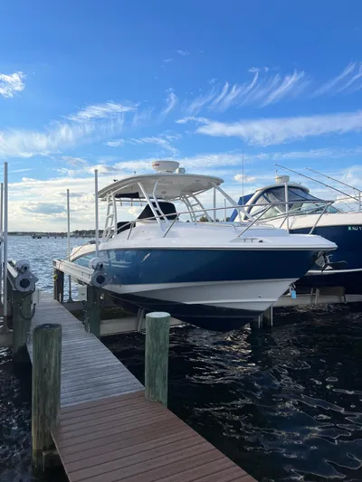  Yacht Photos Pics 2011 Boston Whaler 320 Outrage Cuddy Cabin docked by the water.