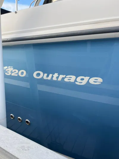  Yacht Photos Pics 2011 Boston Whaler 320 Outrage Cuddy Cabin, blue hull detail.