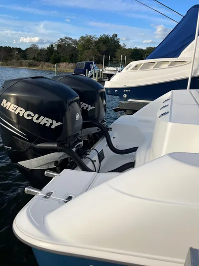  Yacht Photos Pics 2011 Boston Whaler 320 Outrage with twin Mercury outboards docked on calm water.