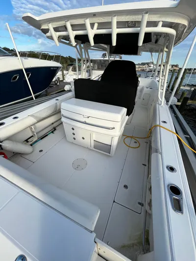  Yacht Photos Pics 2011 Boston Whaler 320 Outrage Cuddy Cabin boat interior, spacious deck, and seating area.