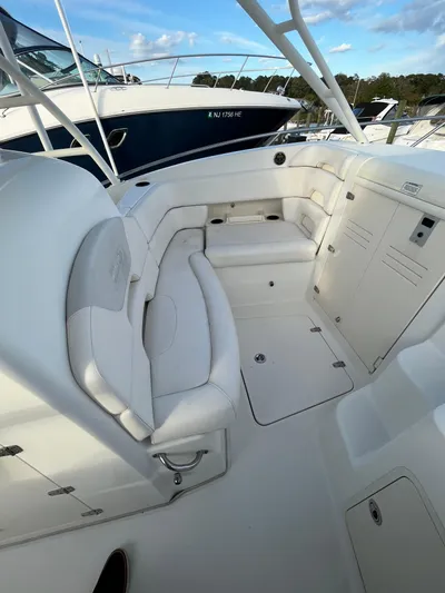  Yacht Photos Pics 2011 Boston Whaler 320 Outrage Cuddy Cabin interior with white seating and storage.