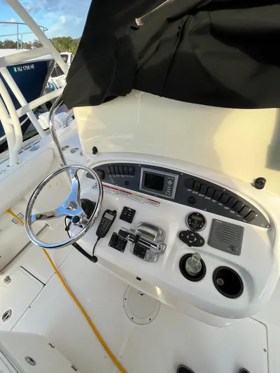  Yacht Photos Pics 2011 Boston Whaler 320 Outrage Cuddy Cabin helm with steering wheel and controls.