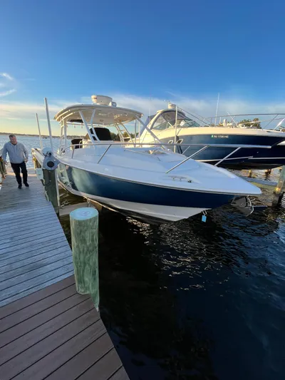  Yacht Photos Pics 2011 Boston Whaler 320 Outrage Cuddy Cabin docked at marina.