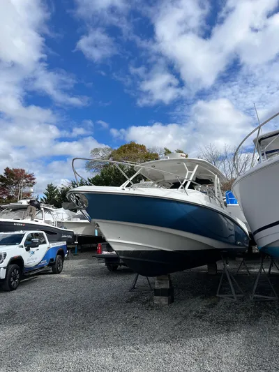  Yacht Photos Pics 2011 Boston Whaler 320 Outrage Cuddy Cabin on display under a partly cloudy sky.