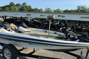 2012 Ranger Z521 Comanche boat on trailer, parked at dealership with other boats.