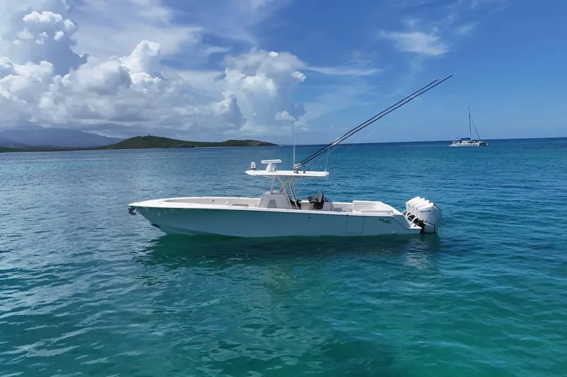  Yacht Photos Pics 2022 SeaVee 390Z boat on clear blue ocean with scenic island backdrop.