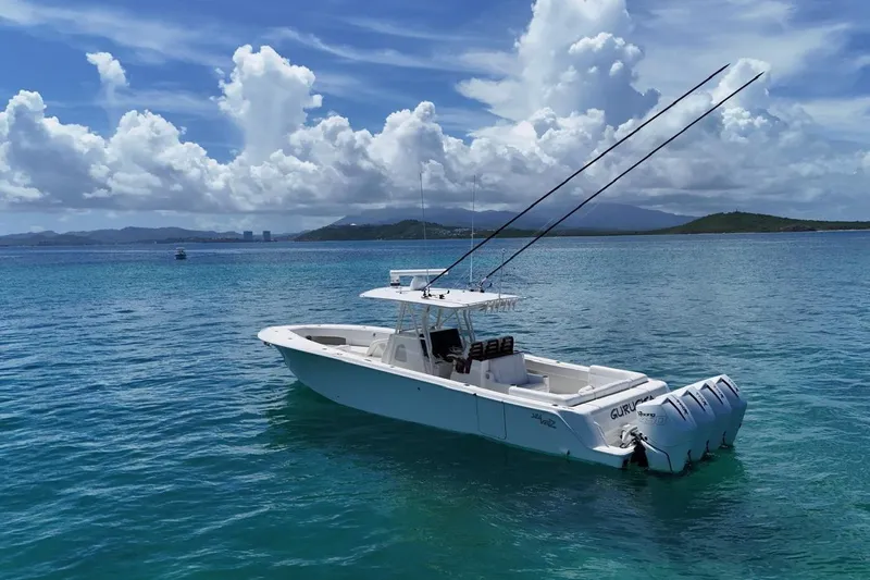  Yacht Photos Pics 2022 SeaVee 390Z boat on clear blue water under a partly cloudy sky.