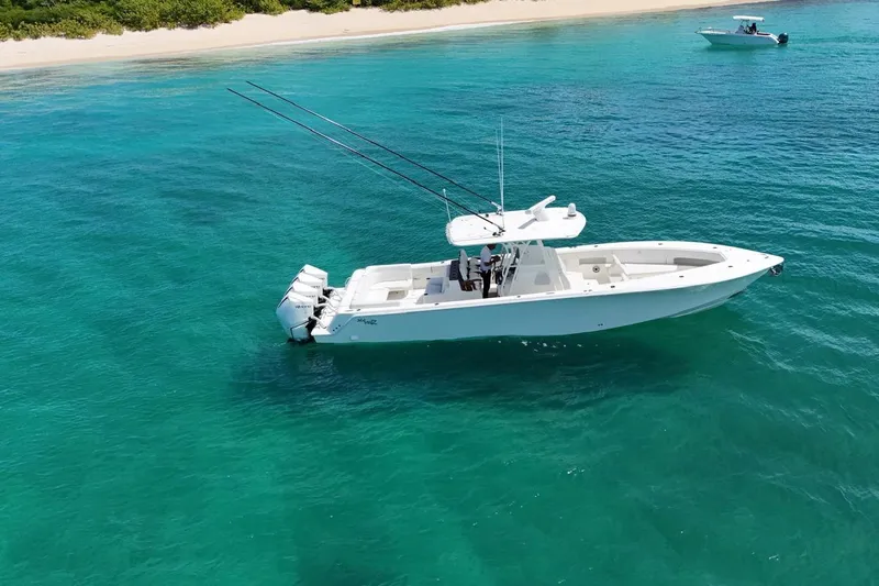  Yacht Photos Pics 2022 SeaVee 390Z boat on clear turquoise water near a sandy beach.