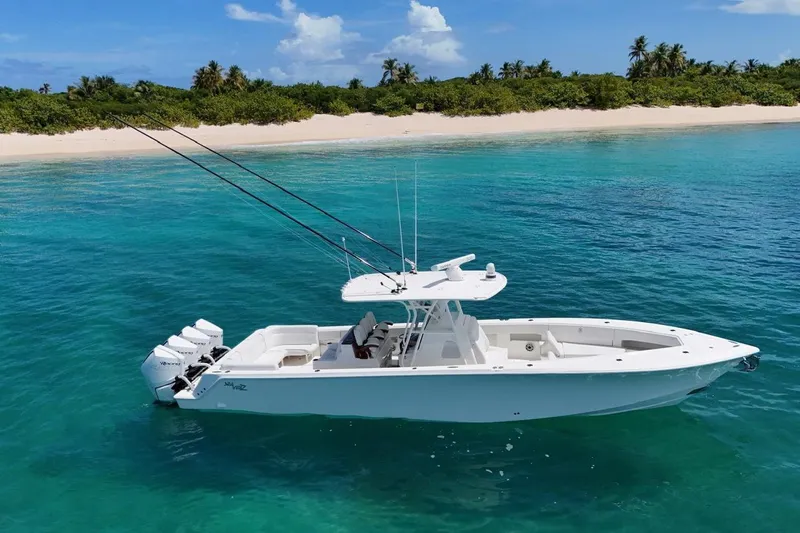  Yacht Photos Pics 2022 SeaVee 390Z boat in clear turquoise water near a sandy beach.