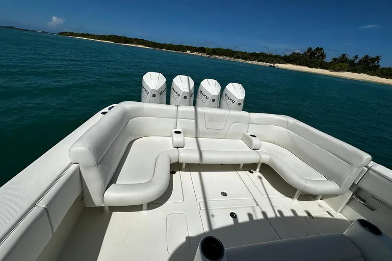  Yacht Photos Pics 2022 SeaVee 390Z boat with white seating, four engines, and ocean backdrop.