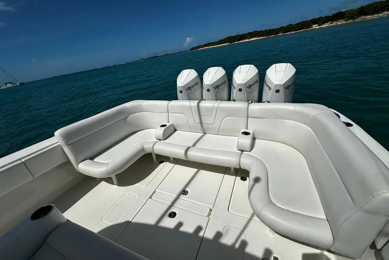  Yacht Photos Pics 2022 SeaVee 390Z boat with white seating and four outboard engines on blue water.