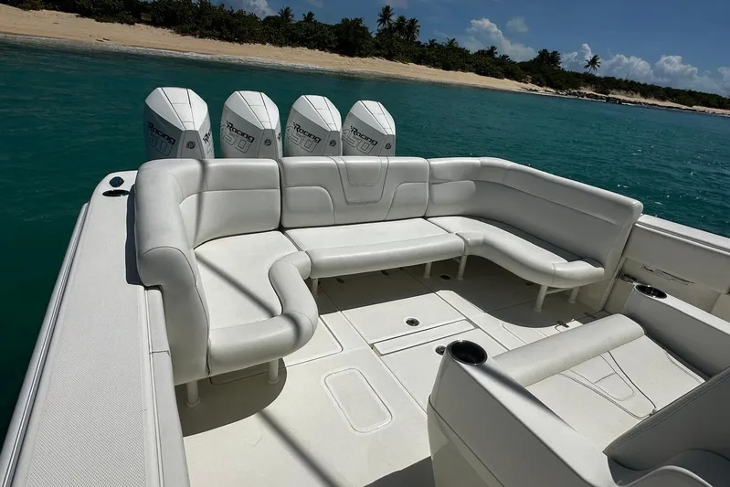  Yacht Photos Pics 2022 SeaVee 390Z boat with white seating, four engines, and tropical beach backdrop.