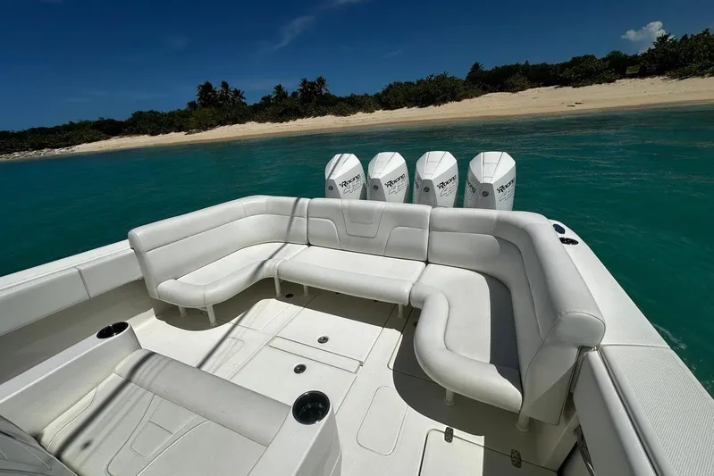  Yacht Photos Pics 2022 SeaVee 390Z boat with white seating, near a tropical beach.