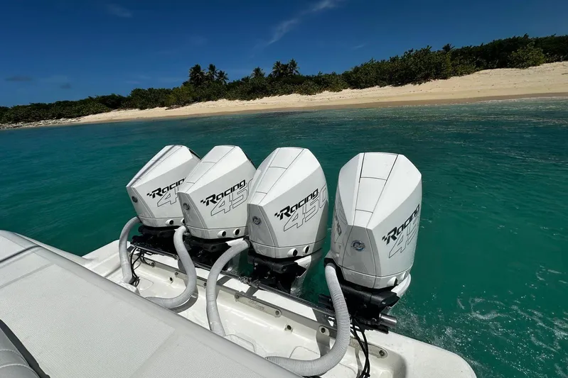  Yacht Photos Pics Four powerful outboard motors on a 2022 SeaVee 390Z near a tropical beach.
