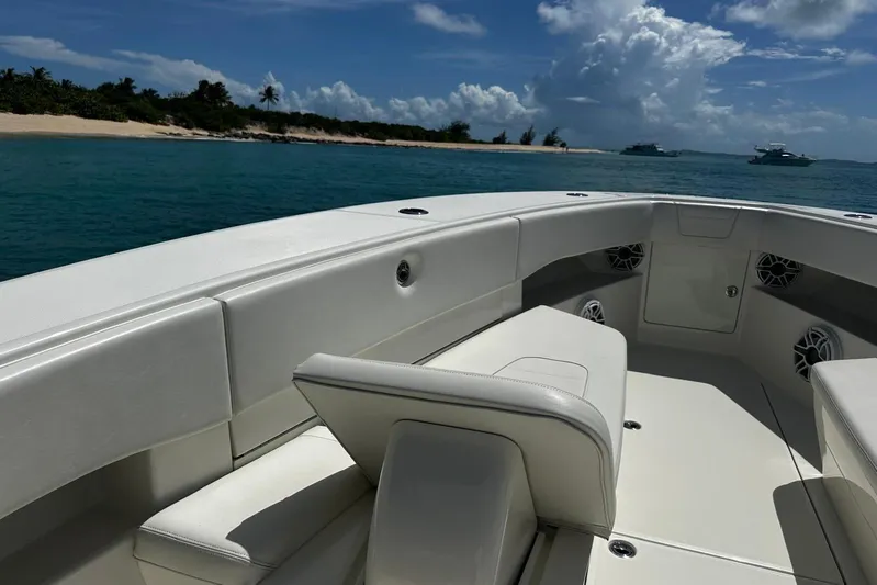  Yacht Photos Pics 2022 SeaVee 390Z boat interior with white seating, near tropical shoreline.