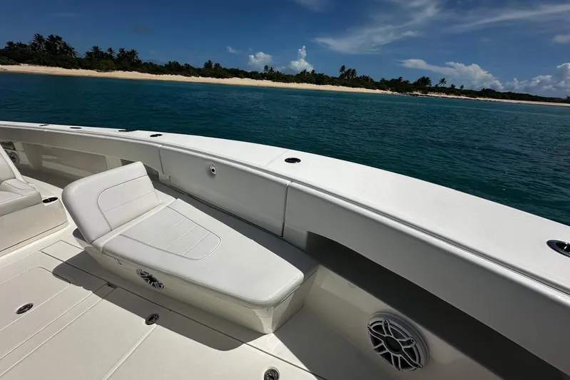  Yacht Photos Pics 2022 SeaVee 390Z boat interior with white seating, ocean view, and sandy beach background.