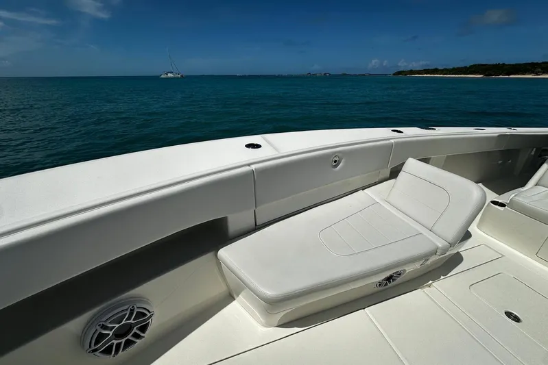 Yacht Photos Pics 2022 SeaVee 390Z boat interior with cushioned seating, ocean view, and clear blue sky.