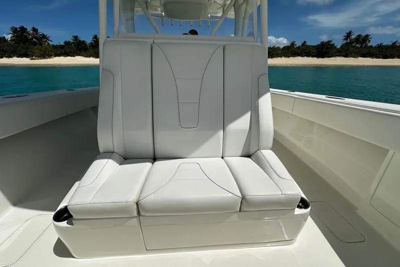  Yacht Photos Pics 2022 SeaVee 390Z boat with white seating, ocean backdrop, and tropical shoreline.