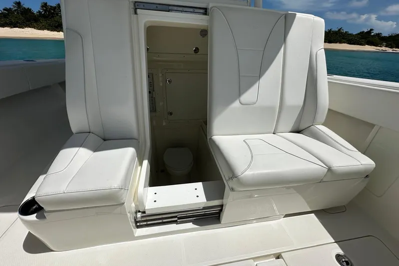  Yacht Photos Pics 2022 SeaVee 390Z boat interior with white seating and hidden compartment.