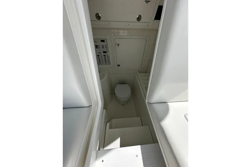  Yacht Photos Pics Interior view of 2022 SeaVee 390Z boat bathroom with toilet and control panel.