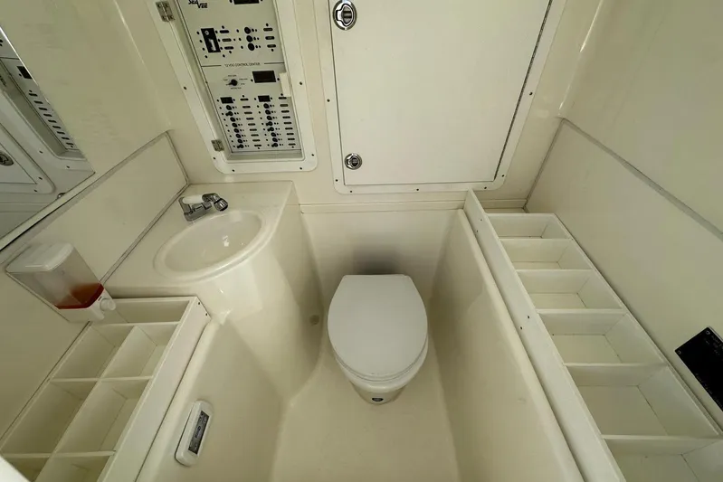  Yacht Photos Pics 2022 SeaVee 390Z boat bathroom with toilet, sink, and control panel.