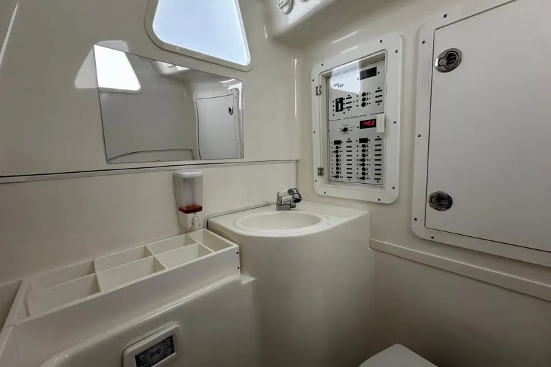  Yacht Photos Pics Interior of 2022 SeaVee 390Z boat featuring control panel, sink, and storage compartments.