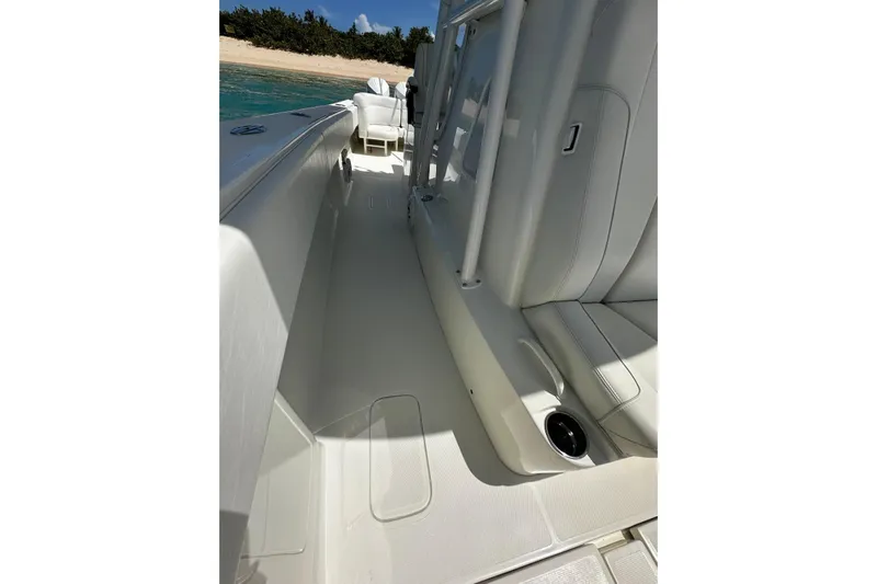  Yacht Photos Pics 2022 SeaVee 390Z boat interior with white seating and sleek design near a sandy beach.