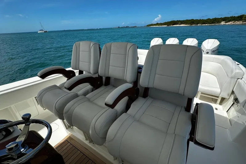  Yacht Photos Pics 2022 SeaVee 390Z boat with luxurious seating, ocean view, and clear blue skies.