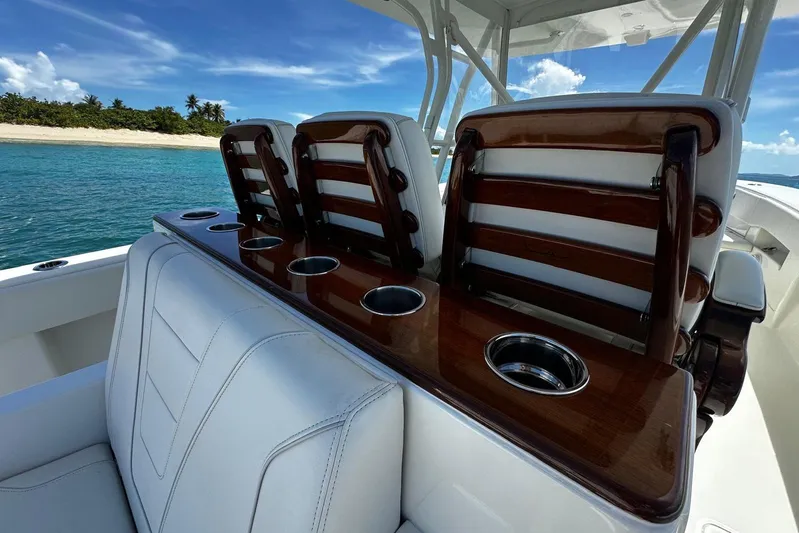  Yacht Photos Pics 2022 SeaVee 390Z boat interior with luxurious seating and cup holders, near a tropical beach.