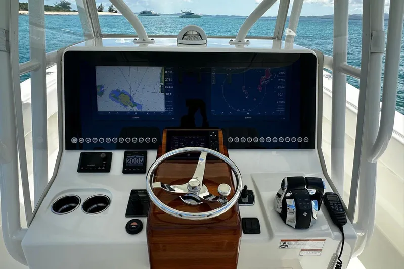  Yacht Photos Pics 2022 SeaVee 390Z boat dashboard with navigation screens and controls, overlooking the ocean.