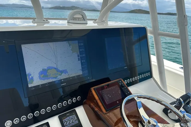  Yacht Photos Pics 2022 SeaVee 390Z boat dashboard with navigation screens and steering wheel.