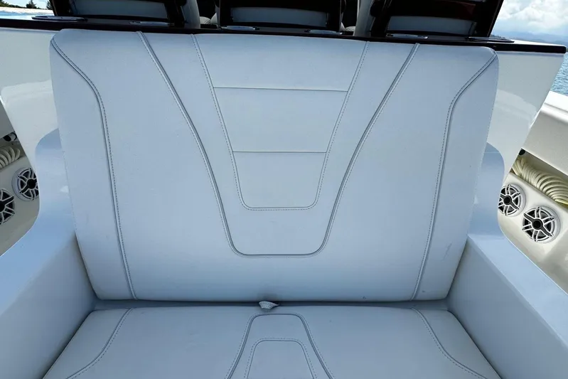  Yacht Photos Pics 2022 SeaVee 390Z boat seat with white upholstery and speaker details.