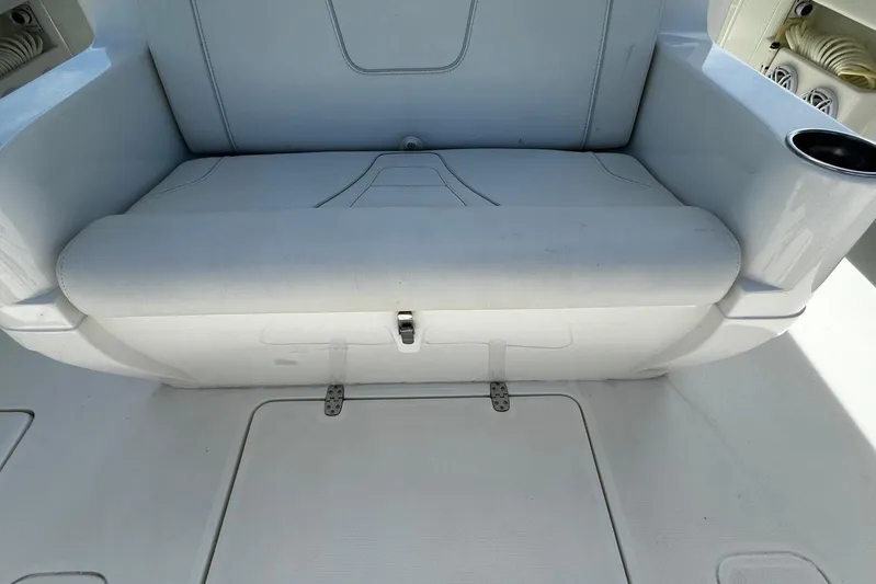  Yacht Photos Pics 2022 SeaVee 390Z boat seat with white upholstery and integrated cup holder.
