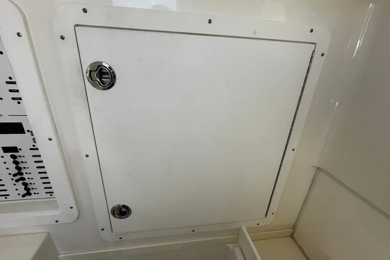  Yacht Photos Pics 2022 SeaVee 390Z boat compartment with control panel and secure latch.