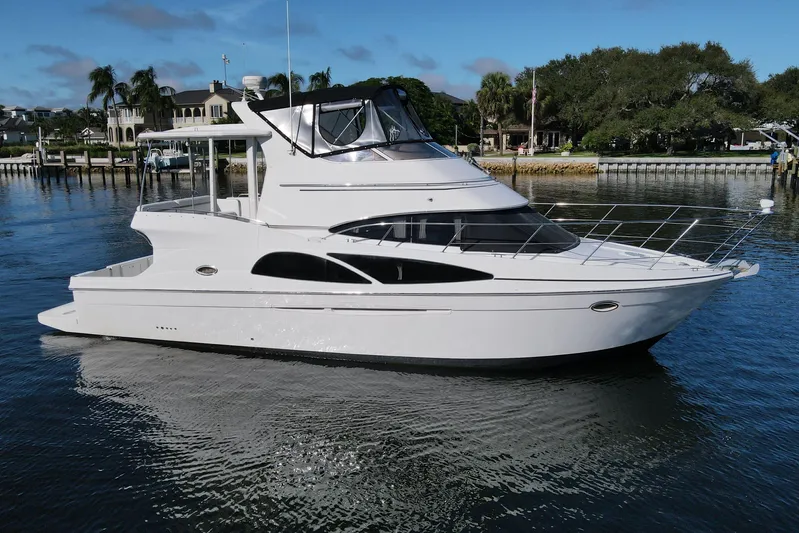 Aloha Spirit Yacht Photos Pics 2005 Carver 41 Cockpit Motor Yacht on calm water, showcasing sleek design and luxury features.