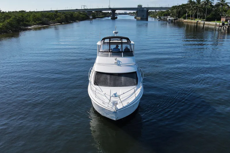 Aloha Spirit Yacht Photos Pics 2005 Carver 41 Cockpit Motor Yacht cruising on a serene waterway.