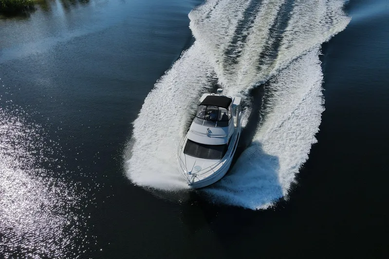 Aloha Spirit Yacht Photos Pics 2005 Carver 41 Cockpit Motor Yacht cruising on a sunny day, creating a wake.