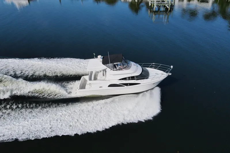Aloha Spirit Yacht Photos Pics 2005 Carver 41 Cockpit Motor Yacht cruising on calm water, aerial view.