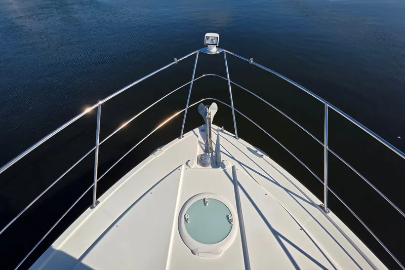 Aloha Spirit Yacht Photos Pics Bow view of 2005 Carver 41 Cockpit Motor Yacht on calm water.