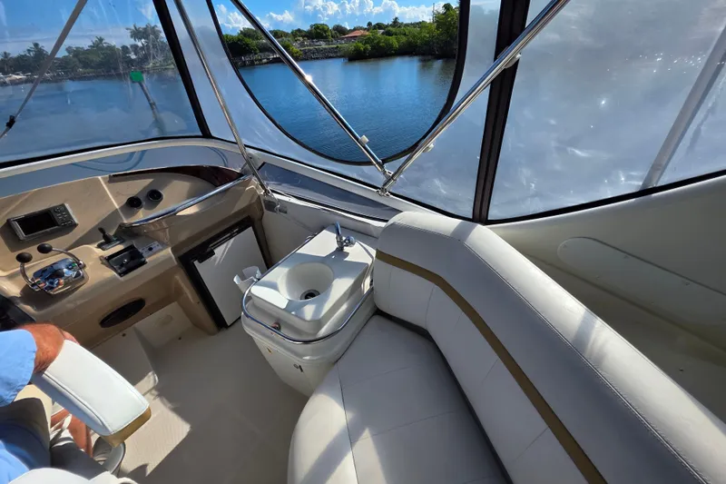 Aloha Spirit Yacht Photos Pics 2005 Carver 41 Cockpit Motor Yacht interior with helm, seating, and water view.