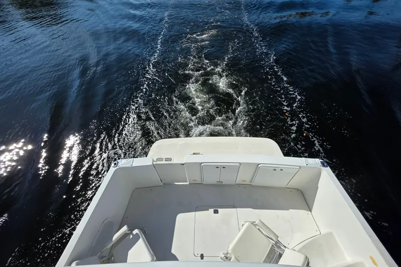 Aloha Spirit Yacht Photos Pics 2005 Carver 41 Cockpit Motor Yacht cruising on water, view from stern.