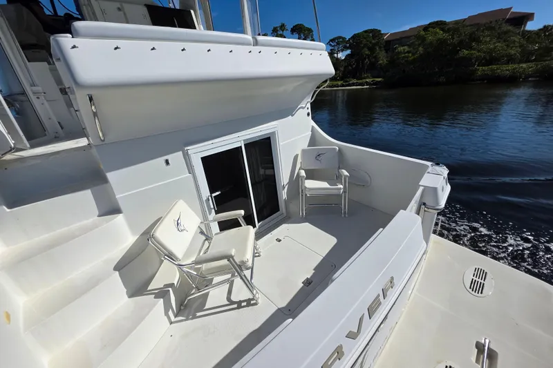 Aloha Spirit Yacht Photos Pics 2005 Carver 41 Cockpit Motor Yacht, spacious deck with chairs, near serene waterway.