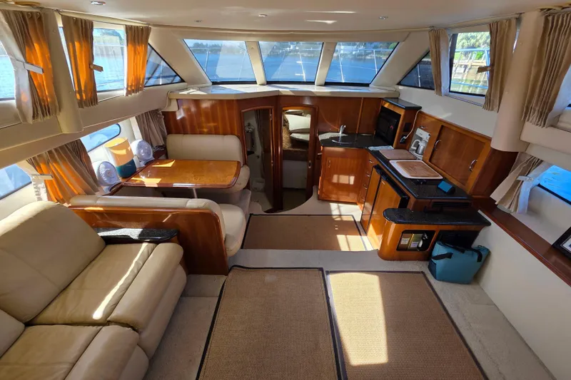 Aloha Spirit Yacht Photos Pics Luxurious interior of 2005 Carver 41 Cockpit Motor Yacht with elegant furnishings and ample natural light.