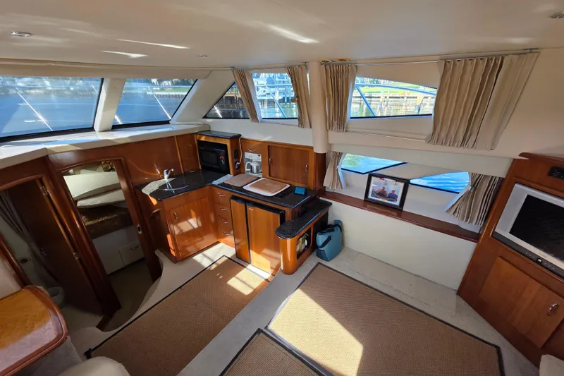 Aloha Spirit Yacht Photos Pics Interior of 2005 Carver 41 Cockpit Motor Yacht with kitchen and large windows.