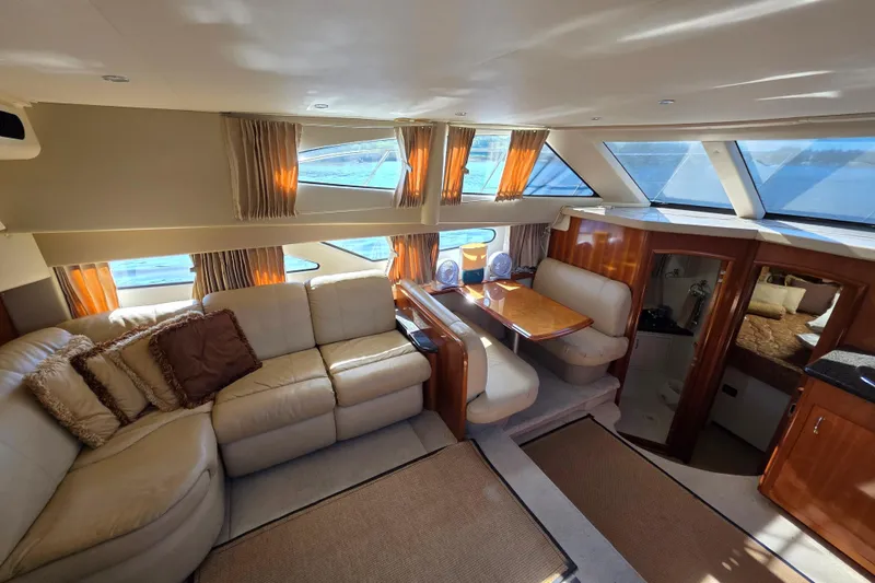 Aloha Spirit Yacht Photos Pics Luxurious interior of 2005 Carver 41 Cockpit Motor Yacht with plush seating and dining area.