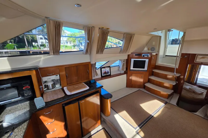 Aloha Spirit Yacht Photos Pics Interior of 2005 Carver 41 Cockpit Motor Yacht with kitchen and living area.