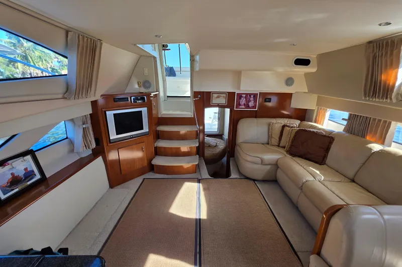 Aloha Spirit Yacht Photos Pics Luxurious interior of 2005 Carver 41 Cockpit Motor Yacht with plush seating and entertainment area.