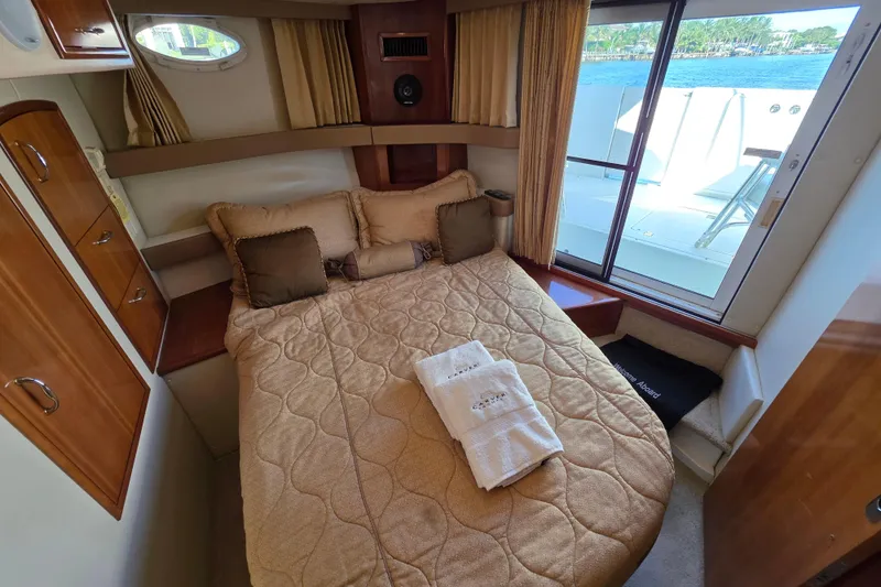Aloha Spirit Yacht Photos Pics Cozy bedroom in 2005 Carver 41 Cockpit Motor Yacht with window view and elegant decor.