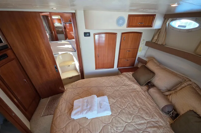 Aloha Spirit Yacht Photos Pics Luxurious interior of 2005 Carver 41 Cockpit Motor Yacht with cozy bedroom and elegant wood finishes.