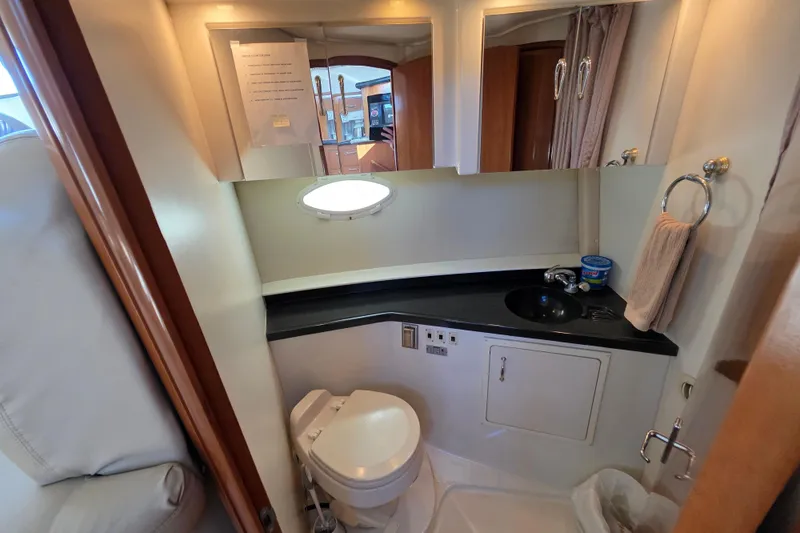 Aloha Spirit Yacht Photos Pics 2005 Carver 41 Cockpit Motor Yacht bathroom with sink, toilet, and mirror.